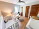 Cozy bedroom featuring a crib, armchair, and wood floors, perfect for a Bedroom at 3205 Brandywine Nw Pl, Marietta, GA 30064