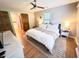 Cozy bedroom featuring hardwood floors, a ceiling fan, and comfortable neutral furniture at 3205 Brandywine Nw Pl, Marietta, GA 30064
