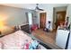 A bedroom featuring a ceiling fan, wooden closet doors, and carpeted floors at 3205 Brandywine Nw Pl, Marietta, GA 30064