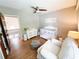 Bedroom with a white crib, changing table, white chair, hardwood floors, and ceiling fan at 3205 Brandywine Nw Pl, Marietta, GA 30064