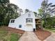 View of the home's back exterior with a one-car garage and second story patio at 3205 Brandywine Nw Pl, Marietta, GA 30064