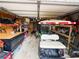 Organized garage space with ample storage, a workbench, and a golf cart at 3205 Brandywine Nw Pl, Marietta, GA 30064