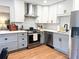 Modern kitchen with stainless steel appliances, shaker cabinets, and stylish backsplash at 3205 Brandywine Nw Pl, Marietta, GA 30064
