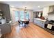 Eat-in kitchen features a bay window and pendant lighting over the round dining table at 3205 Brandywine Nw Pl, Marietta, GA 30064