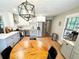 Open kitchen design with stainless steel appliances, granite counter tops, and a modern light fixture above dining table at 3205 Brandywine Nw Pl, Marietta, GA 30064