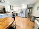 Bright kitchen featuring stainless appliances, white cabinets, and a round wooden table with black chairs at 3205 Brandywine Nw Pl, Marietta, GA 30064