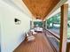 Inviting covered porch with a wooden ceiling, a ceiling fan, and comfortable seating at 3205 Brandywine Nw Pl, Marietta, GA 30064