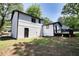 Backyard exterior of a two story house with an adjacent deck and tree covered backyard at 3959 Wood Path Dr, Stone Mountain, GA 30083