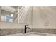 Close-up of a bathroom vanity featuring a speckled granite countertop and modern black faucet at 3959 Wood Path Dr, Stone Mountain, GA 30083
