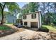 Beautiful two-story house with a front porch and attached garage on a sunny day at 3959 Wood Path Dr, Stone Mountain, GA 30083