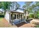Charming home with a cozy front porch and well-manicured lawn, perfect for relaxing outdoors at 3959 Wood Path Dr, Stone Mountain, GA 30083