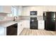 Modern kitchen featuring granite countertops, white cabinets and black appliances at 3959 Wood Path Dr, Stone Mountain, GA 30083