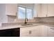 Modern kitchen featuring granite countertops, white cabinetry, and stainless steel appliances at 3959 Wood Path Dr, Stone Mountain, GA 30083