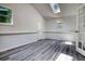 Bright living room with neutral walls, skylight, and updated flooring at 3959 Wood Path Dr, Stone Mountain, GA 30083