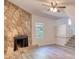 Living room with decorative stone fireplace and updated flooring at 3959 Wood Path Dr, Stone Mountain, GA 30083