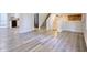 Open concept living room with modern flooring, stairs, and open kitchen at 3959 Wood Path Dr, Stone Mountain, GA 30083