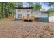 View of the back of the house with a wooden deck and an outdoor entrance at 798 Brownlee Ln, Lawrenceville, GA 30044