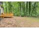 The level backyard space and a wooden deck create an ideal outdoor living area at 798 Brownlee Ln, Lawrenceville, GA 30044