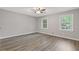 Bright bedroom featuring wood-look floors, neutral walls, and backyard views at 798 Brownlee Ln, Lawrenceville, GA 30044