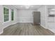 Dining area featuring luxury vinyl flooring, modern light fixture, and a pass through to the kitchen at 798 Brownlee Ln, Lawrenceville, GA 30044