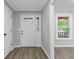Clean entryway with gray walls, vinyl floors, and white trim, featuring a window and a white front door at 798 Brownlee Ln, Lawrenceville, GA 30044