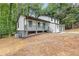 An exterior view of a home with a front porch, an attached garage, and fresh landscaping at 798 Brownlee Ln, Lawrenceville, GA 30044