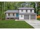 Charming two-story home featuring a well-manicured lawn, a two-car garage, and a welcoming blue front door at 798 Brownlee Ln, Lawrenceville, GA 30044