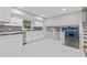 Modern kitchen with white cabinets, tiled backsplash, stainless steel appliances, and an open layout to the living area at 798 Brownlee Ln, Lawrenceville, GA 30044