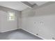 Neutral laundry room with tile flooring, washer-dryer hookups, and a window at 798 Brownlee Ln, Lawrenceville, GA 30044