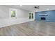 Bright living room featuring light gray walls, wood-look floors, and a painted brick fireplace at 798 Brownlee Ln, Lawrenceville, GA 30044