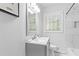 Bright bathroom featuring a marble-tiled shower, modern vanity, and stylish fixtures at 2425 Clifton Springs Rd, Decatur, GA 30034
