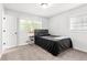 Clean bedroom with neutral carpet, a minimalist headboard, and a bright window at 2425 Clifton Springs Rd, Decatur, GA 30034