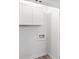 Clean laundry room featuring white cabinets, new flooring, and convenient hookups at 2425 Clifton Springs Rd, Decatur, GA 30034