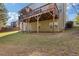 Backyard with a grassy lawn and a wooden deck with a gazebo at 3213 Blackley Old Rd, Douglasville, GA 30135