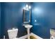 Blue half bathroom with white pedestal sink and white toilet at 3213 Blackley Old Rd, Douglasville, GA 30135