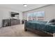 Bedroom with light carpet, gray walls, and a wooden bed frame near a window at 3213 Blackley Old Rd, Douglasville, GA 30135