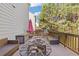 Wooden deck with wicker furniture, a fire pit and wooded view at 3213 Blackley Old Rd, Douglasville, GA 30135