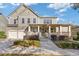 Charming two-story house with a welcoming front porch, and stone accents, providing ample curb appeal at 3213 Blackley Old Rd, Douglasville, GA 30135