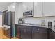Modern kitchen with sleek black countertops, subway tile backsplash, and stainless steel appliances at 3213 Blackley Old Rd, Douglasville, GA 30135