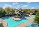 Aerial view showcasing a luxurious community pool and clubhouse, ideal for leisure and social events at 3213 Blackley Old Rd, Douglasville, GA 30135