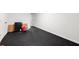 The unfinished basement space with rubber flooring offers storage space and potential at 3714 Westbrooke Ne Cir, Brookhaven, GA 30319