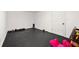 The basement offers potential with rubber flooring and painted white walls and ceiling at 3714 Westbrooke Ne Cir, Brookhaven, GA 30319