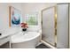 Well-lit bathroom features a jacuzzi tub next to shower with gold trim, with a decorative window at 3714 Westbrooke Ne Cir, Brookhaven, GA 30319