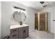 Bathroom featuring a gray vanity, bright light, and shower stall with white walls at 3714 Westbrooke Ne Cir, Brookhaven, GA 30319