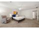 Bedroom featuring carpet, a ceiling fan, and a crib with view to the ensuite bathroom at 3714 Westbrooke Ne Cir, Brookhaven, GA 30319