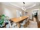 Dining room with modern lighting, large table, and access to other rooms in the home at 3714 Westbrooke Ne Cir, Brookhaven, GA 30319