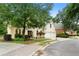 Elegant home showcasing lush landscaping, a brick driveway, and an attached two-car garage at 3714 Westbrooke Ne Cir, Brookhaven, GA 30319