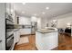 Beautiful kitchen includes white cabinets, stainless appliances, large island with bar seating and hardwood floors at 3714 Westbrooke Ne Cir, Brookhaven, GA 30319