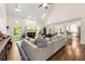 Spacious living room with a cozy fireplace, tall windows, and hardwood floors at 3714 Westbrooke Ne Cir, Brookhaven, GA 30319