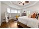 Comfortable main bedroom features tray ceiling, plush bedding, and lots of light at 3714 Westbrooke Ne Cir, Brookhaven, GA 30319